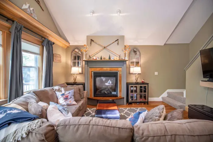 Large living room featuring a comfy couch, Smart TV, and gas fireplace