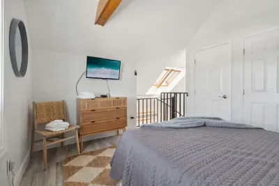 Loft bedroom with queen bed and smart TV
