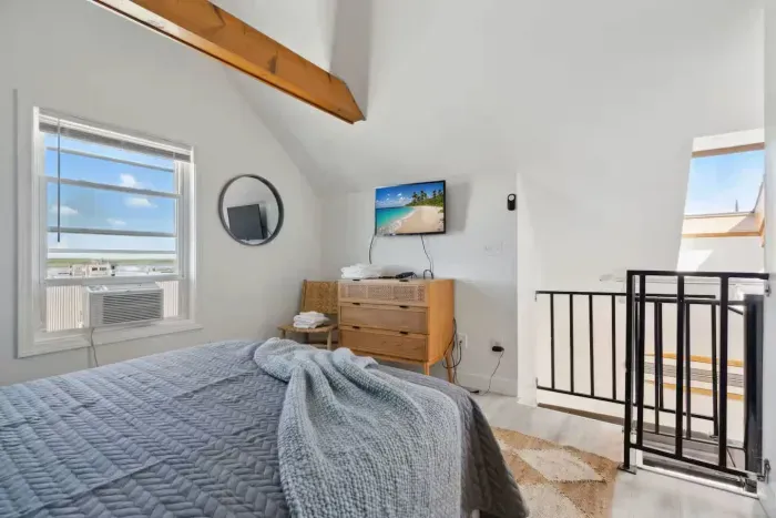 Loft bedroom with queen bed and smart TV