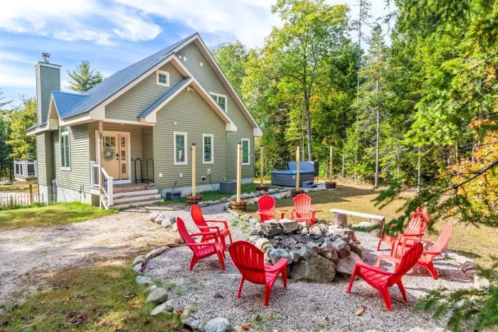 Welcome to Mitten Pines Cabin! Enjoy the firepit, hot tub, and string lights at night!