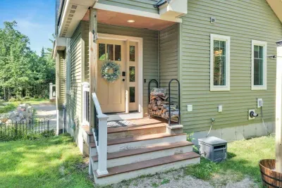 Entrance located at the back of the cabin near the fire pit and hot tub