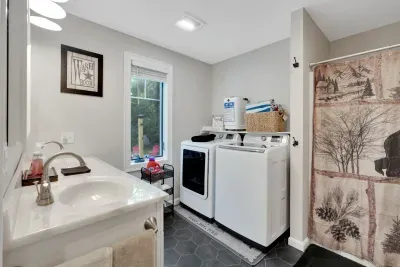 Full bathroom located across the hall from the Primary bedroom. Stand up shower, and towel warmer! Hot tub towels are located here for the capacity of the hot tub