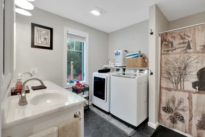 Full bathroom located across the hall from the Primary bedroom. Stand up shower, and towel warmer! Hot tub towels are located here for the capacity of the hot tub