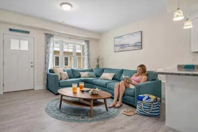 Open living room & kitchen with sleeper sofa, mounted smart TV, strong WiFi and fully-equipped kitchen.