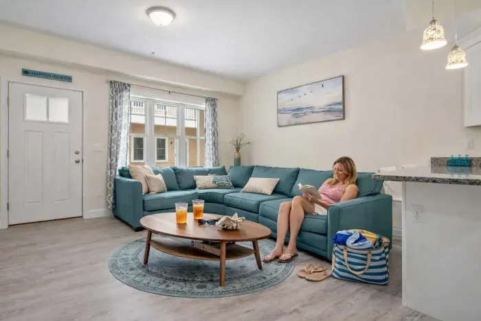 Open living room & kitchen with sleeper sofa, mounted smart TV, strong WiFi and fully-equipped kitchen.