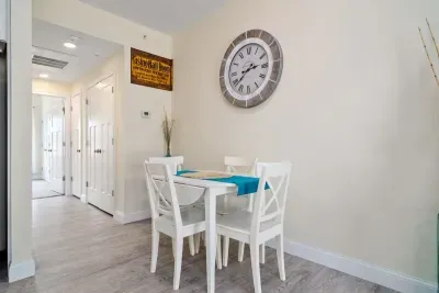 Open living room & kitchen with sleeper sofa, mounted smart TV, strong WiFi and fully-equipped kitchen