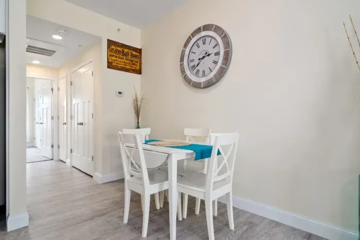 Open living room & kitchen with sleeper sofa, mounted smart TV, strong WiFi and fully-equipped kitchen