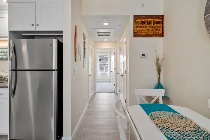 Open living room & kitchen with sleeper sofa, mounted smart TV, strong WiFi and fully-equipped kitchen