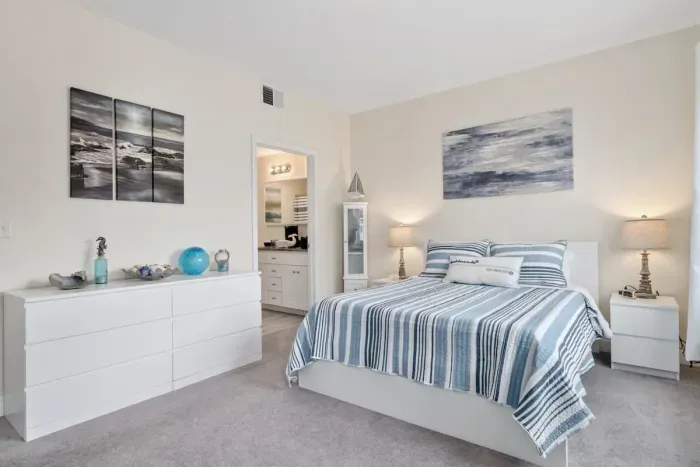 Bedroom with ensuite bathroom with double sink, stand up shower and stackable washer & dryer