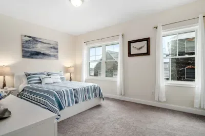 Bedroom with ensuite bathroom with double sink, stand up shower and stackable washer & dryer