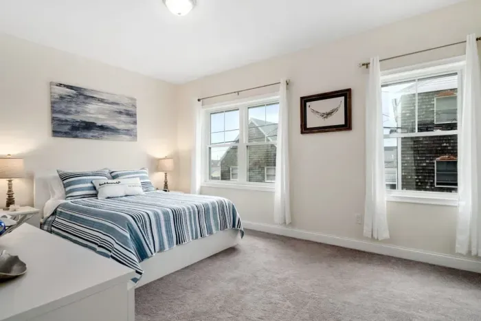 Bedroom with ensuite bathroom with double sink, stand up shower and stackable washer & dryer