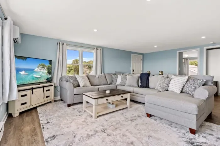 Living room, with sleeper sofa, and stunning unobstructed views of the ocean. DISCLAIMER - this couch has been swapped out. The new couch is slightly larger, a darker grey and has a Queen sleeper (instead of a full).