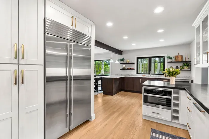 Fully renovated luxury kitchen featuring wolf induction stove/oven, sub-zero refrigerator/freezer, instant hot water dispenser, and a dishwasher. Kitchen is fully equipped.