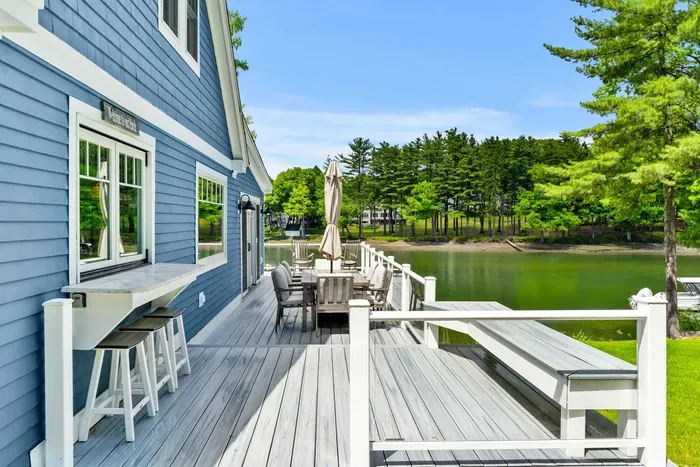Deck with bar seating for three, a six-person outdoor dining table with umbrella, and a gas grill for guest use. Plus a stunning view!