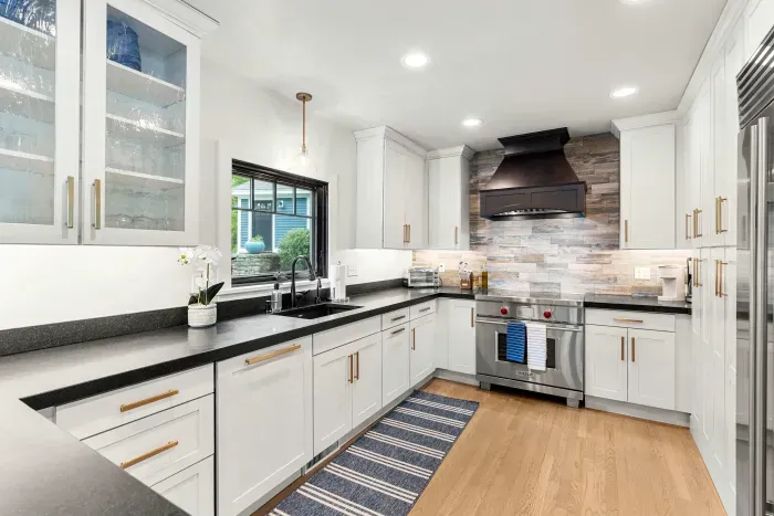 Fully renovated luxury kitchen featuring wolf induction stove/oven, sub-zero refrigerator/freezer, instant hot water dispenser, and a dishwasher. Kitchen is fully equipped.