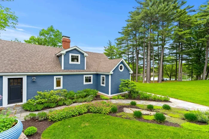 Backside of the Creekhouse equipped with a gorgeous lawn and garden.
