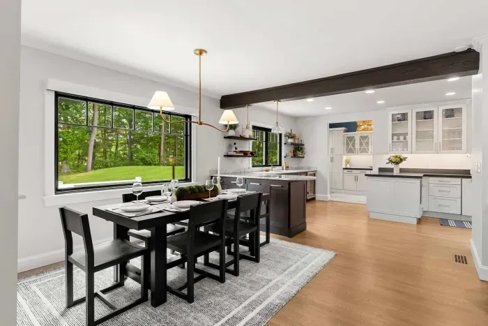 6 person dining table located off the kitchen, two additional barstools are available for bar seating.