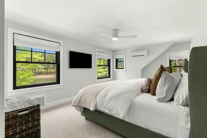 Second level primary bedroom featuring a king size bed, views of Sagamore Creek, and a walk in closet. Clean and 100% cotton linens are provided.
