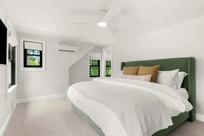 Second level primary bedroom featuring a king size bed, views of Sagamore Creek, and a walk in closet. Clean and 100% cotton linens are provided.