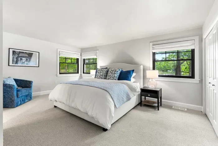 The first level primary bedroom features a king-size bed with clean, 100% cotton linens and beautiful views of Sagamore Creek — a peaceful spot to start and end each day.