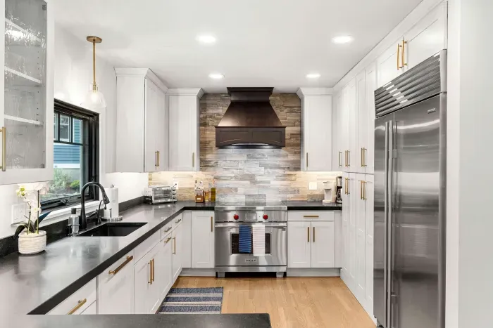 Fully renovated luxury kitchen featuring wolf induction stove/oven, sub-zero refrigerator/freezer, instant hot water dispenser, and a dishwasher. Kitchen is fully equipped.