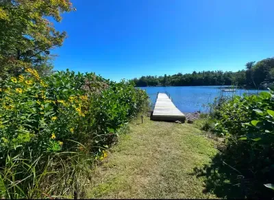The dock is available for use during the summer months. This home is located in a calm cove. The dock will be new summer 2025!