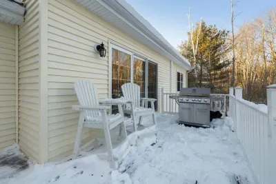 The deck is located off of the dining room - there is a large gas grill with seating for 2