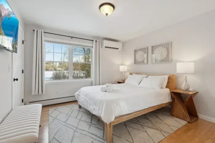 The Primary Bedroom is located on the main level of the home. It has fabulous views of Lake Winnisquam! Clean linens provided and high quality Thuma beds throughout the Queen bedrooms