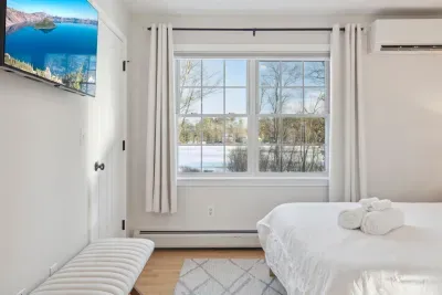 The Primary Bedroom! Clean linens provided. High quality, Thuma beds are in every Queen bedroom! There is a smart TV in this bedroom too! There are luggage racks in every bedroom!