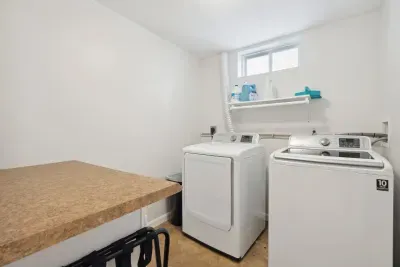 The laundry room is located on the lower level of the home