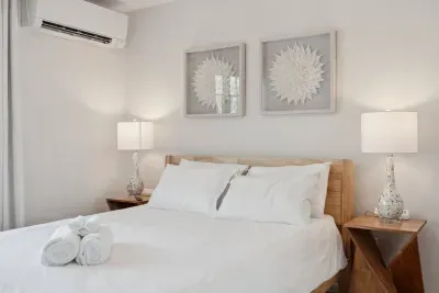 The Primary Bedroom! Clean linens provided. High quality, Thuma beds are in every Queen bedroom! There is a smart TV in this bedroom too! There are luggage racks in every bedroom!