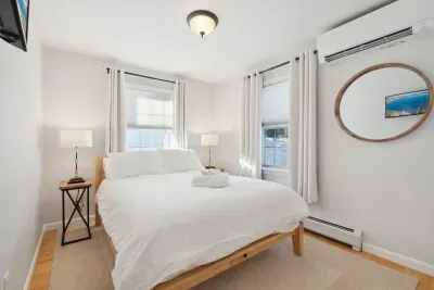 Bedroom #2 located on the main level of the home. This room has a high wuality Thuma Queen bed, luggage rack and smart TV! Clean linens provided