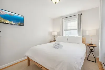 Bedroom #2 located on the main level of the home. This room has a high wuality Thuma Queen bed, luggage rack and smart TV! Clean linens provided