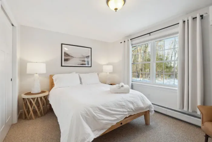 Bedroom #4 located on the downstairs level of the home. This room has a high quality Thuma Queen bed, luggage rack and smart TV! Clean linens provided