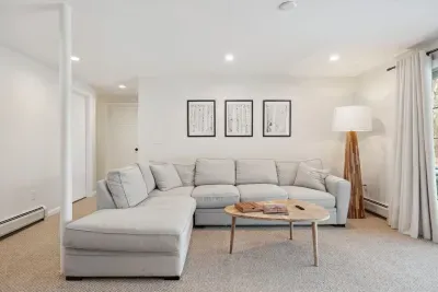 The downstairs family room with Queen sleeper sofa, smart TV, puzzles, and access to the back yard. Clean linens provided for the sleeper!