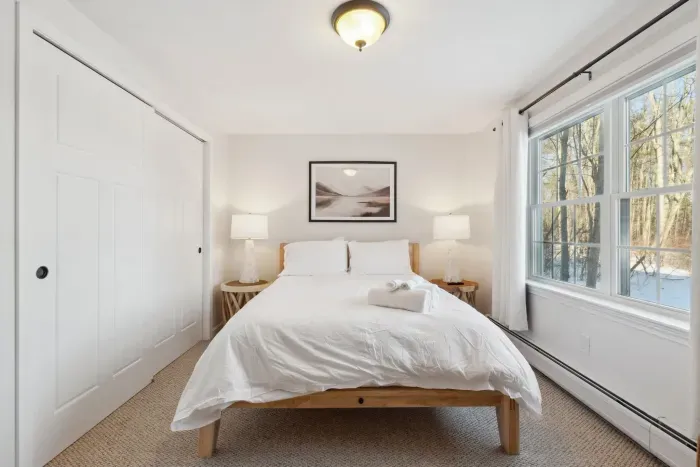 Bedroom #4 located on the downstairs level of the home. This room has a high quality Thuma Queen bed, luggage rack and smart TV! Clean linens provided