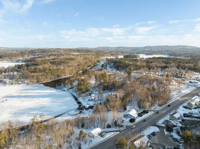 Aerial view of the home. There is a large fence diving the home from this road but please note this is a busy road.