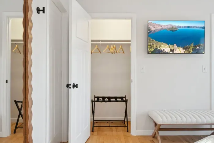 The Primary Bedroom! Clean linens provided. High quality, Thuma beds are in every Queen bedroom! There is a smart TV in this bedroom too! There are luggage racks in every bedroom!