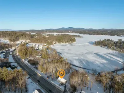 Aerial view of the home. There is a large fence diving the home from this road but please note this is a busy road.