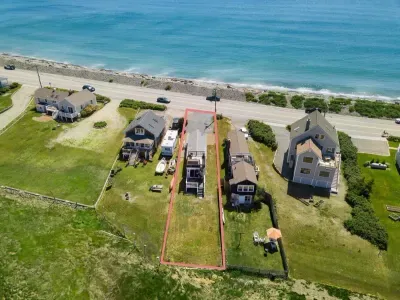 Aerial view, across the street from the ocean, large private lawn area and roof deck to relax, sunbath and grill