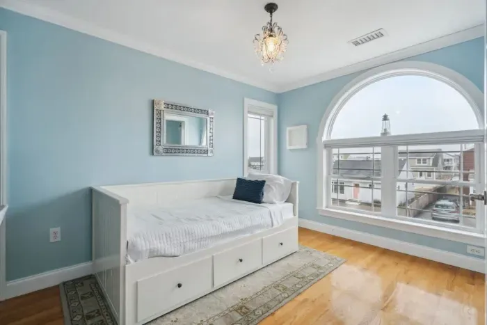 Bedroom #4 with twin-sized day bed, work-from-home desk, and half-bathroom