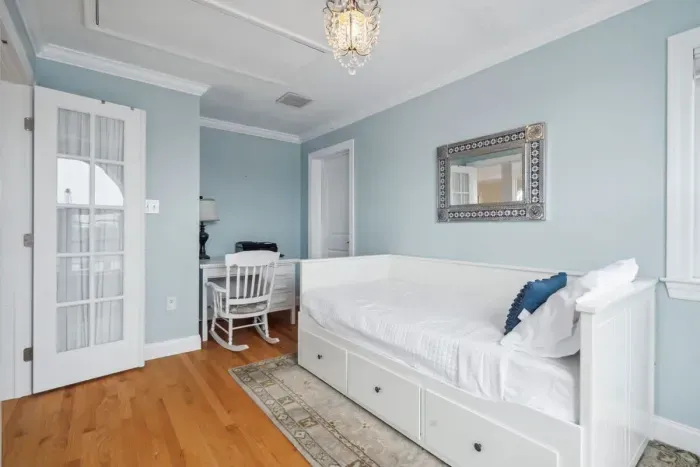 Bedroom #4 with twin-sized day bed, work-from-home desk, and half-bathroom