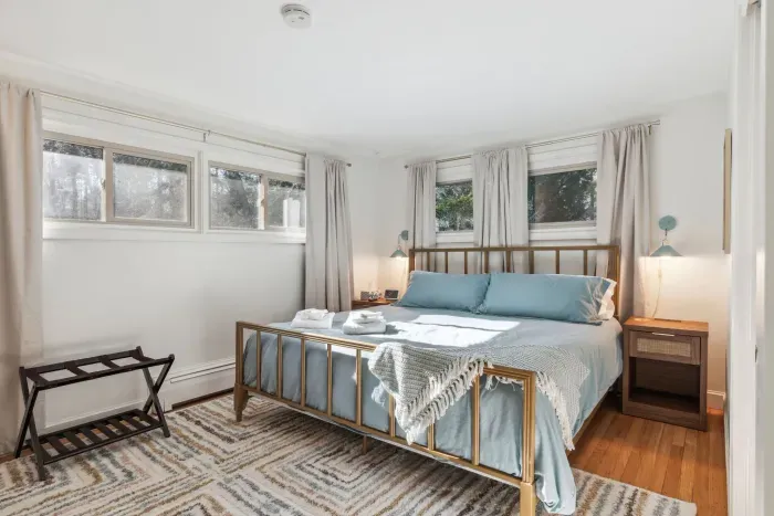 Primary Bedroom with smart tv, luggage racks, a bureau and closet for storage. Clean linens provided