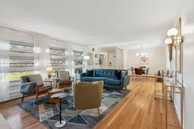 The living room with 3 chairs, a comfy 3 seater couch, and smart TV! Please note - the fireplace is inoperable