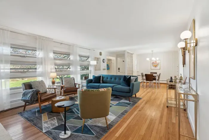 The living room with 3 chairs, a comfy 3 seater couch, and smart TV! Please note - the fireplace is inoperable