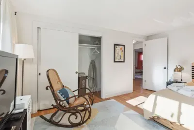 Bedroom #2 with a queen bed! Plenty of storage with a dresser and closet. Smart TV and rocking chair! Clean linens provided