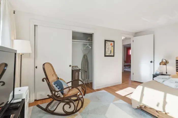 Bedroom #2 with a queen bed! Plenty of storage with a dresser and closet. Smart TV and rocking chair! Clean linens provided