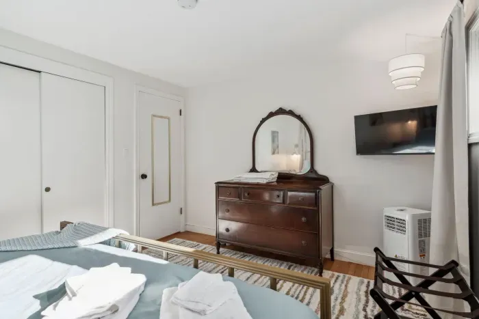 Primary Bedroom with smart tv, luggage racks, a bureau and closet for storage. Clean linens provided