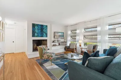 The living room with 3 chairs, a comfy 3 seater couch, and smart TV! Please note - the fireplace is inoperable