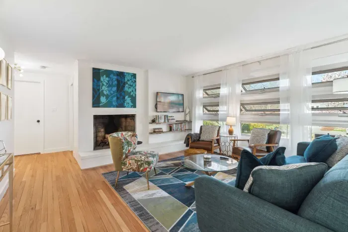 The living room with 3 chairs, a comfy 3 seater couch, and smart TV! Please note - the fireplace is inoperable